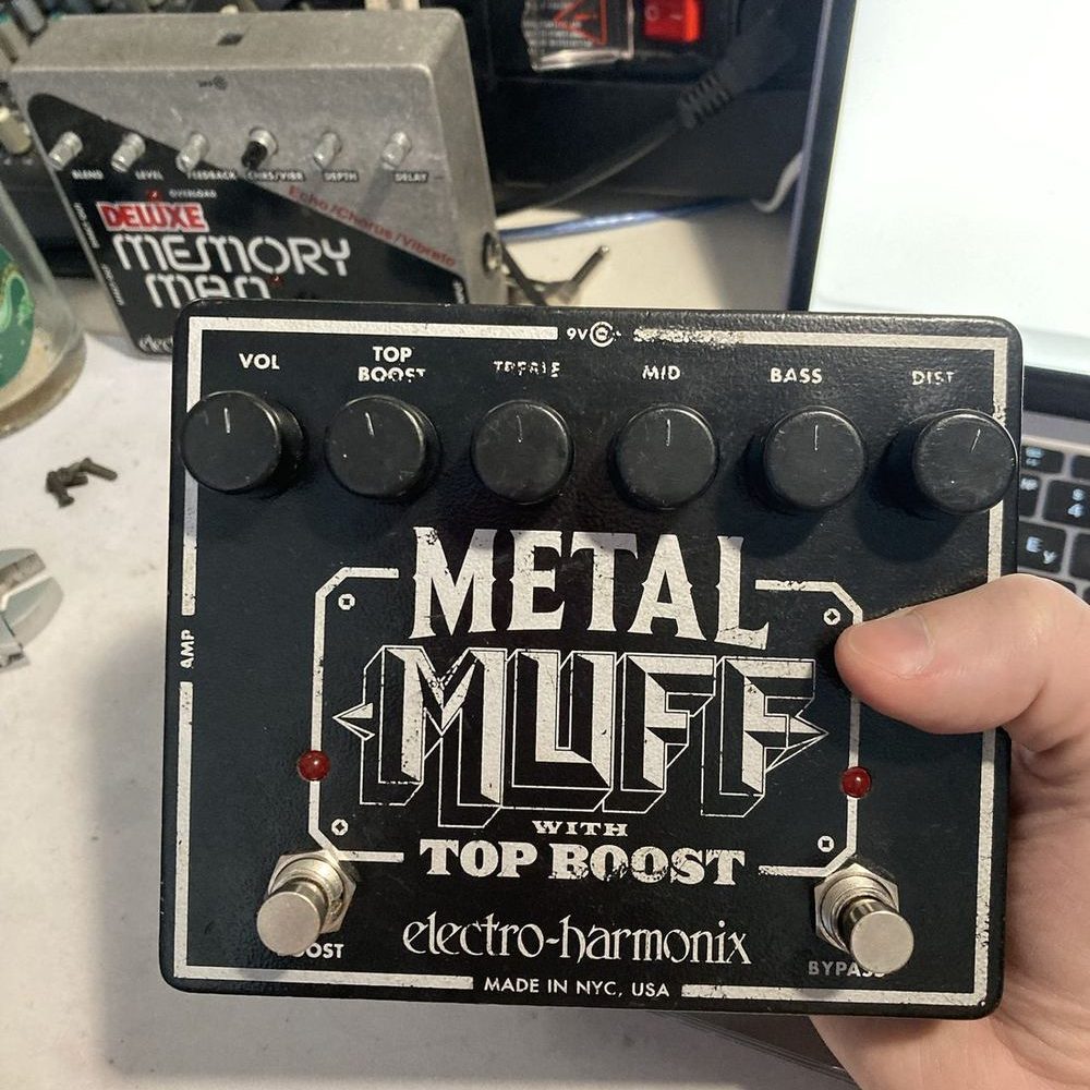 Педаль Electro-Harmonix Metal Muff with Top Boost в руке, за ней Deluxe Memory Man